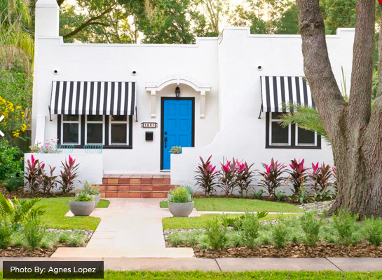 black and white awning on white stucco home